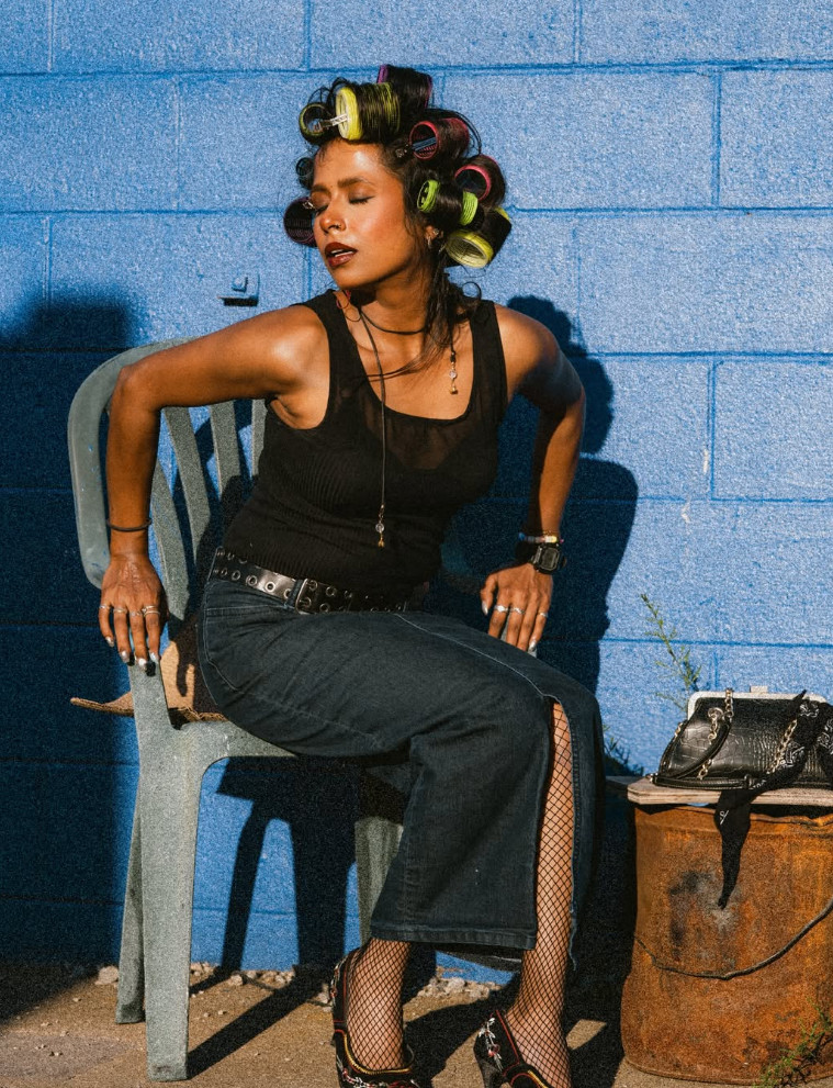 Fashion portrait against a blue wall